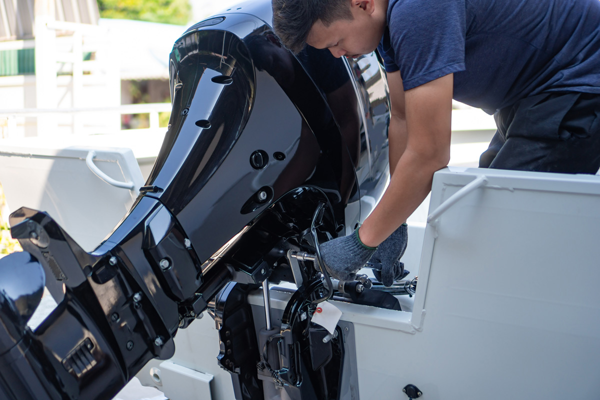 A technician performing maintenance on the back of a boat in El Paso.